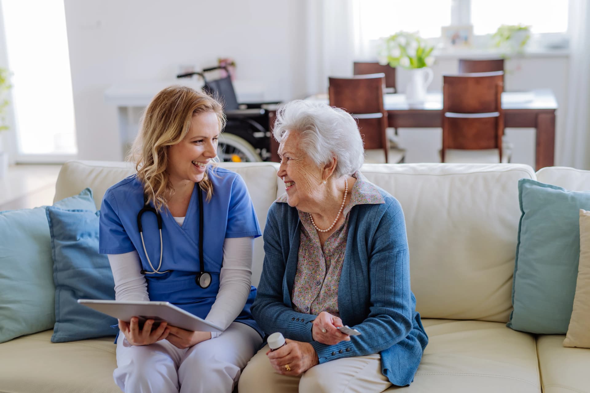 Friendly nurse visiting senior at home