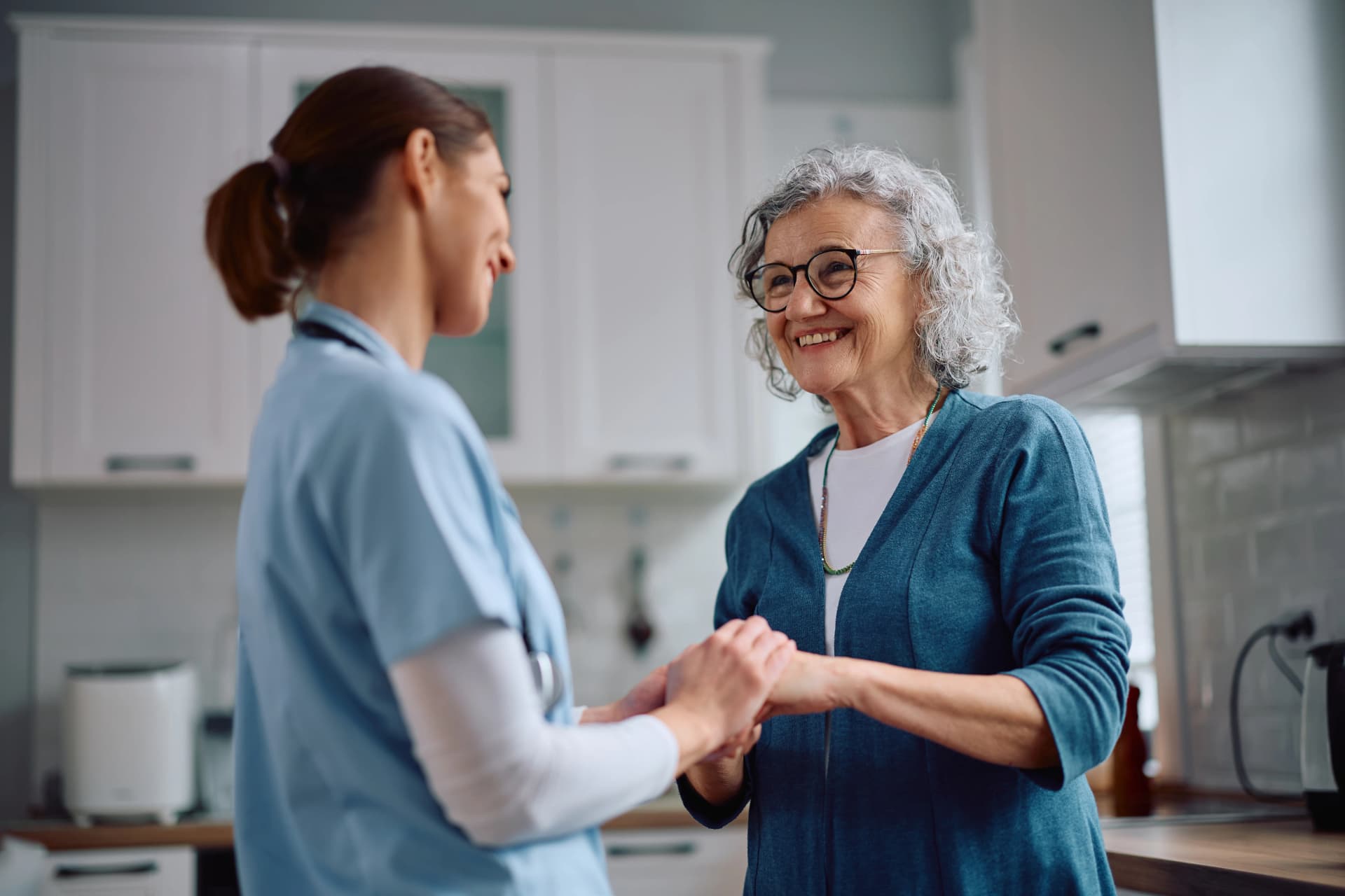 Woman caring for elderly woman at home