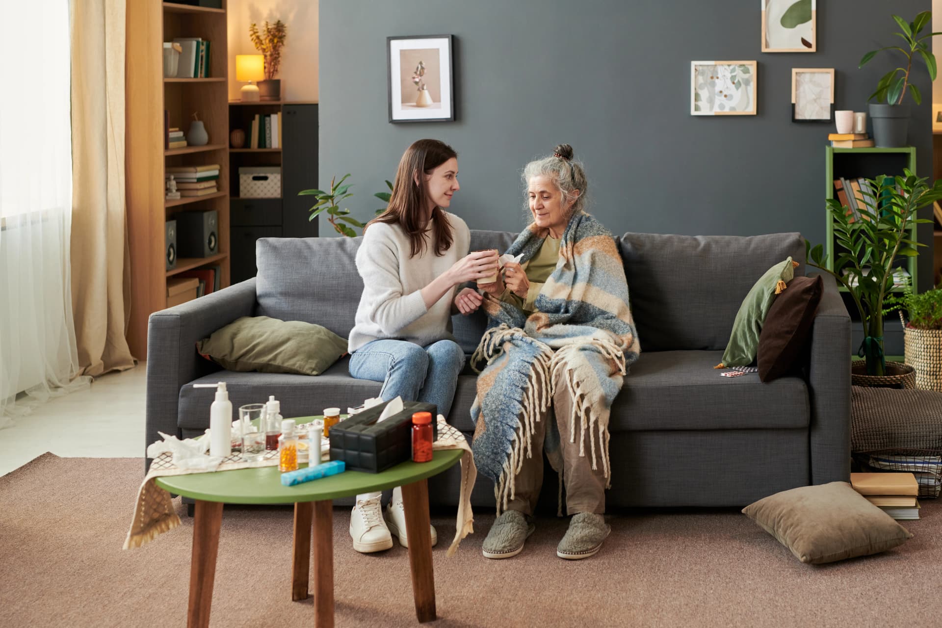 Young woman caring for senior at home
