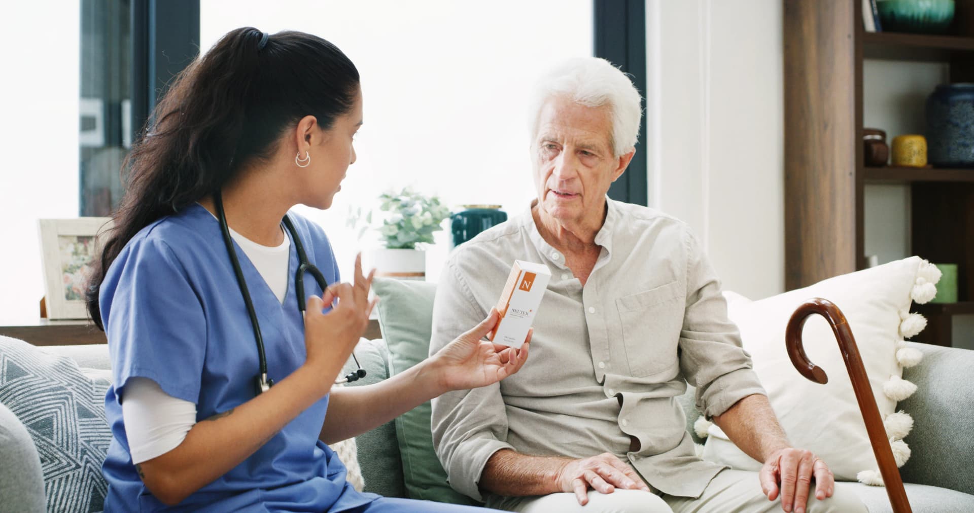 Healthcare worker explaining medication to senior