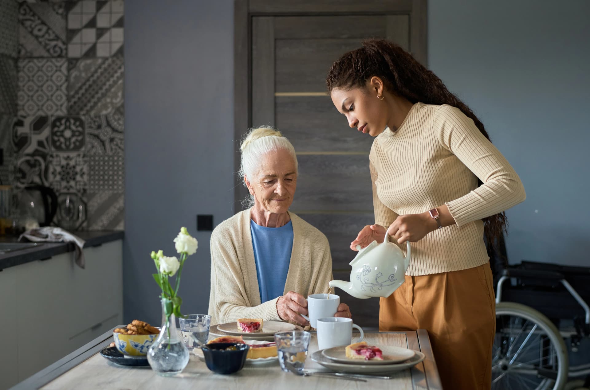 Woman pouring beverage for senior