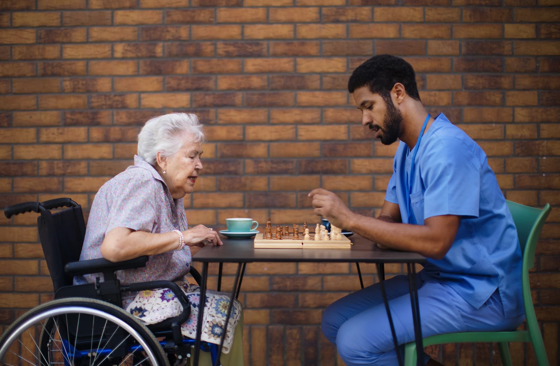 Caregiver calmly engaging a senior with dementia