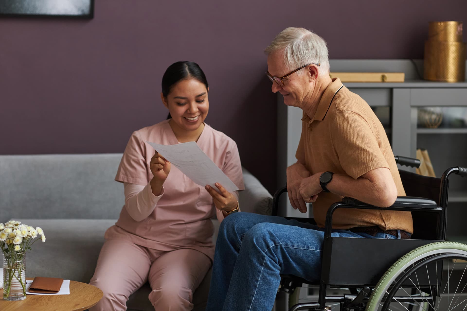 Caregiver reviewing document with senior